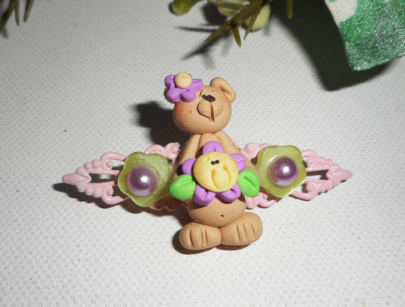 Broche avec ourson et fleur mauve sur estampe rose