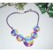 Collier cabochons fleuris multicolores en argile polymère sur cordon en coton ciré violet