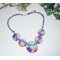 Collier cabochons fleuris multicolores en argile polymère sur cordon en coton ciré violet