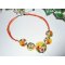 Collier cabochons fleuris oranges en argile polymère sur cordon en coton ciré