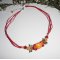 Collier perle fleurie rouge orange avec perles en cristal sur cordon en coton ciré