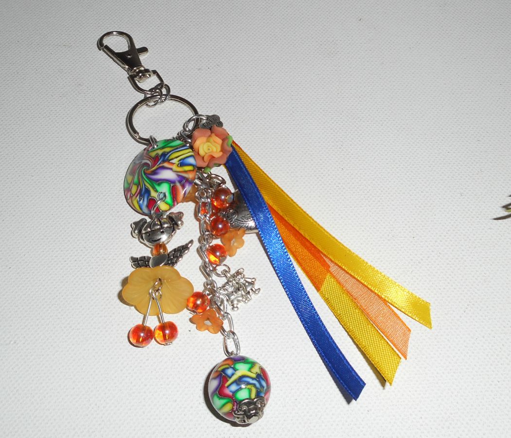 Porte clés/Bijoux de sac poupée orange avec perles et rubans multicolores